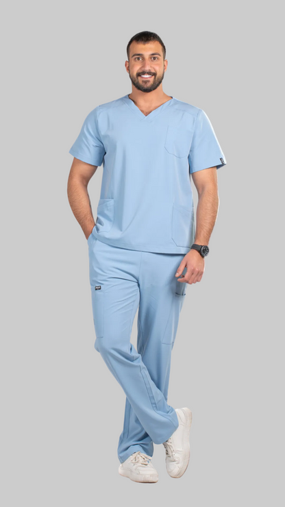 Man wearing light blue medical scrubs on a white background