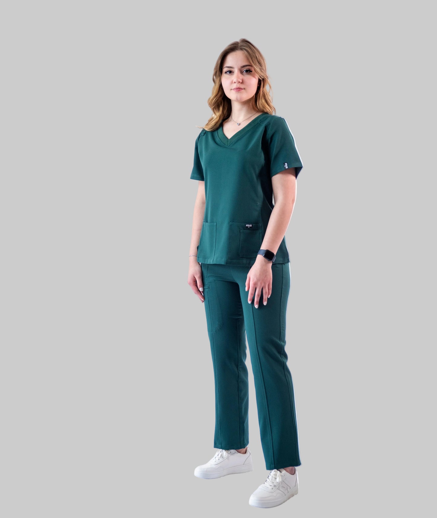 Woman wearing a green scrub set on a white background