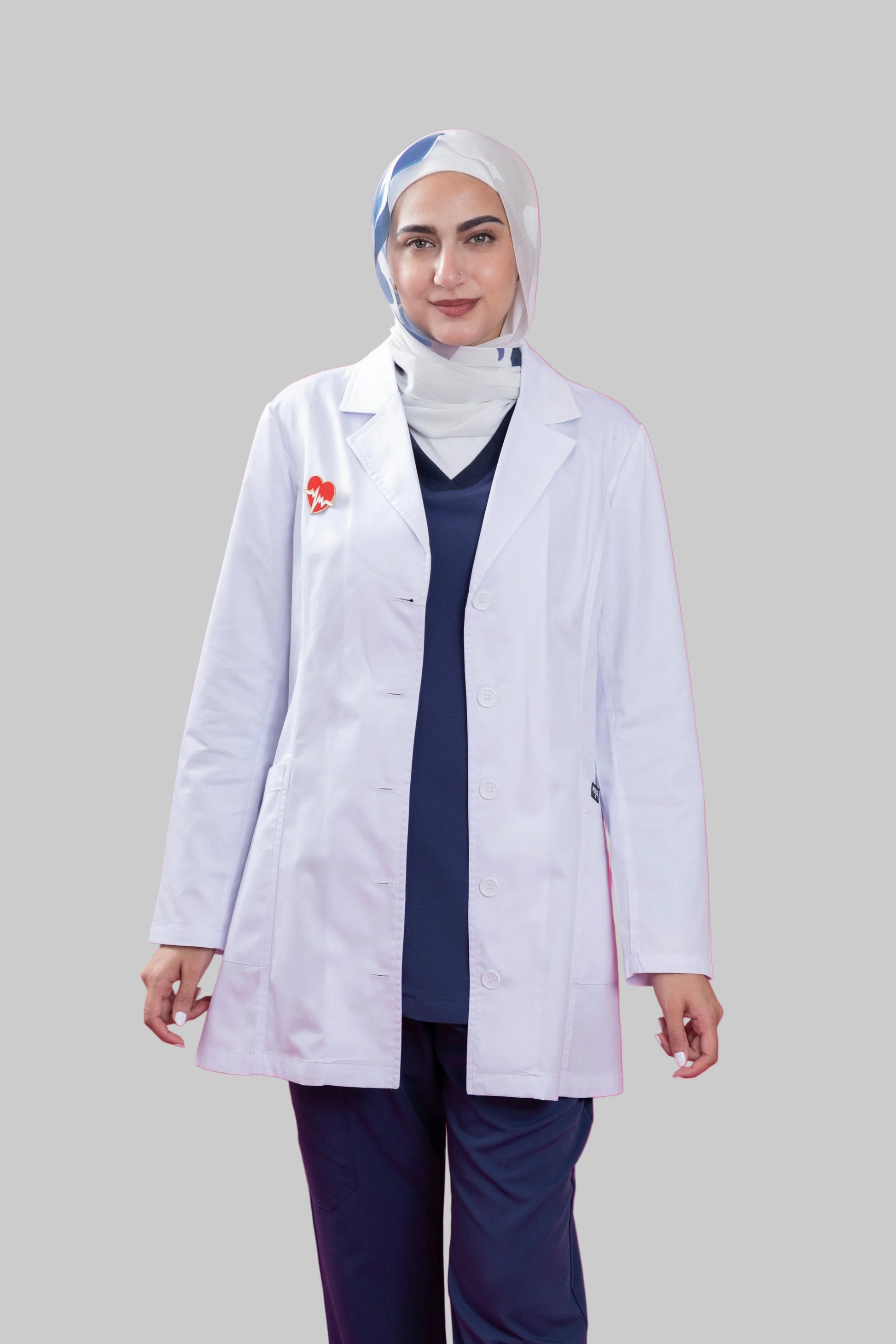 Person wearing a white lab coat with a pink background