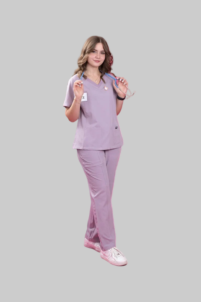 Person wearing a lavender medical scrub set on a white background