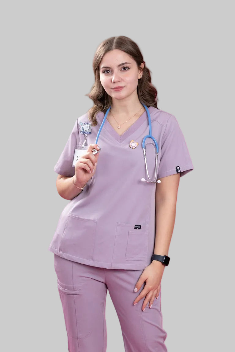 Person wearing lavender medical scrubs with a stethoscope and syringe on a white background