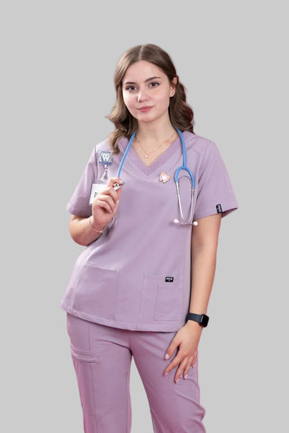 Person wearing lavender medical scrubs with a stethoscope and syringe on a white background
