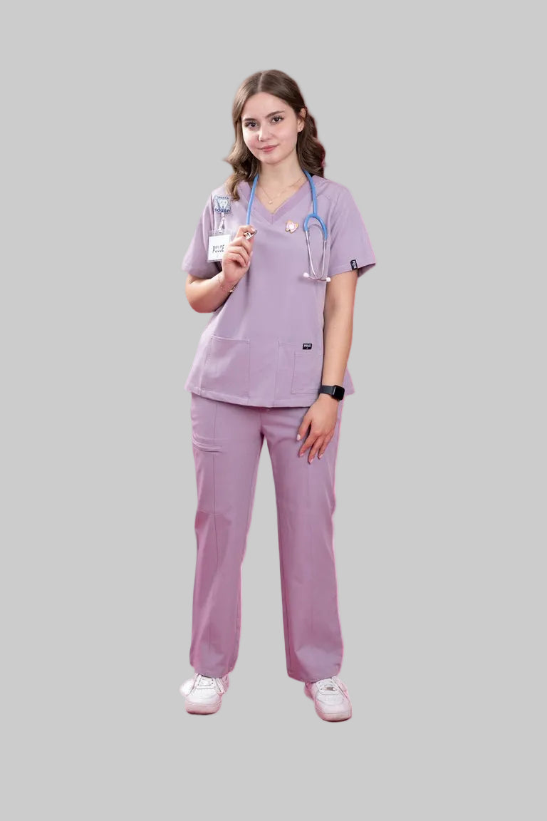 Person wearing a lavender medical scrub set with a stethoscope on a white background