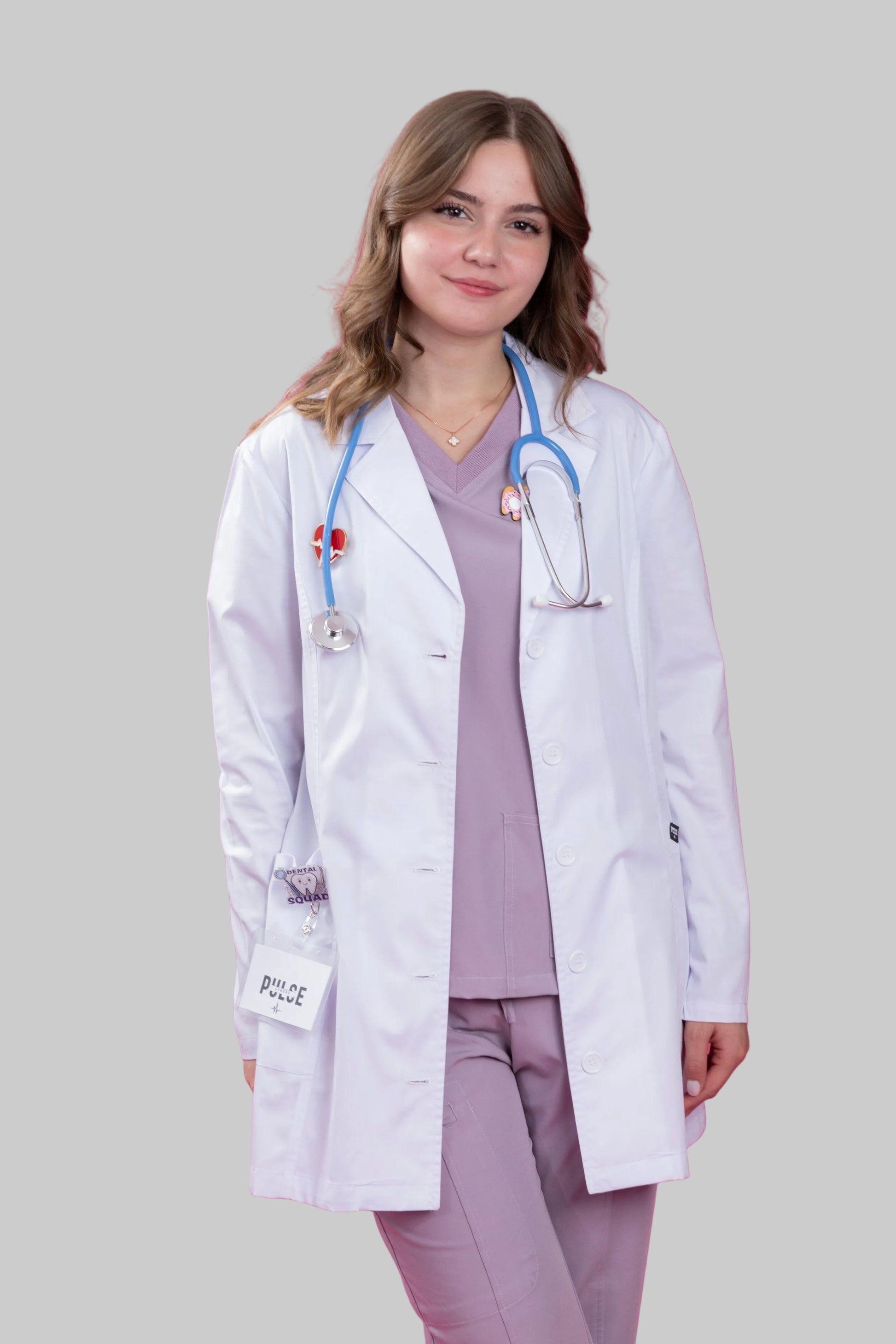 Person wearing a white medical coat and stethoscope on a pink background