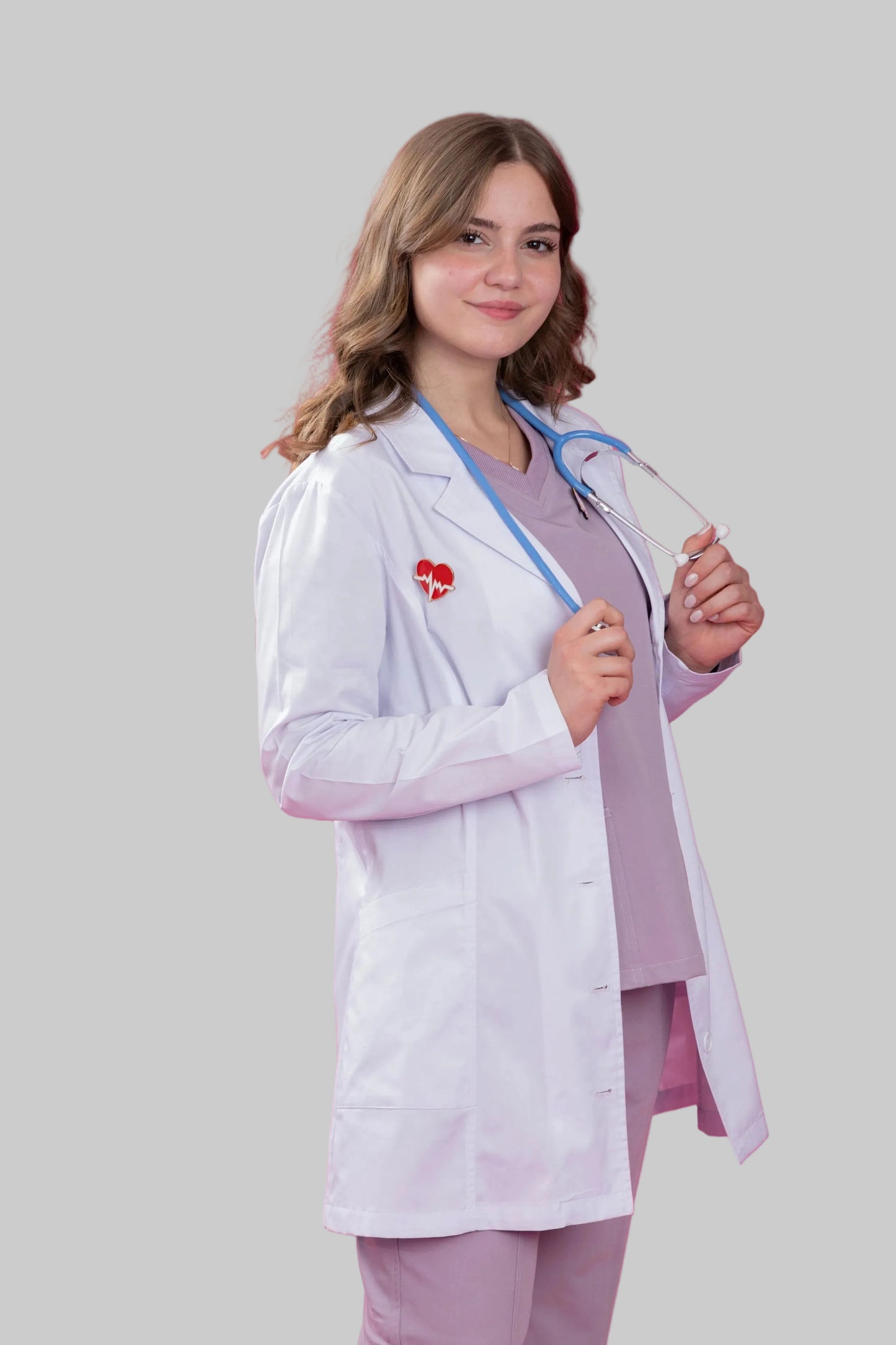 Person wearing a white lab coat and holding glasses against a pink background