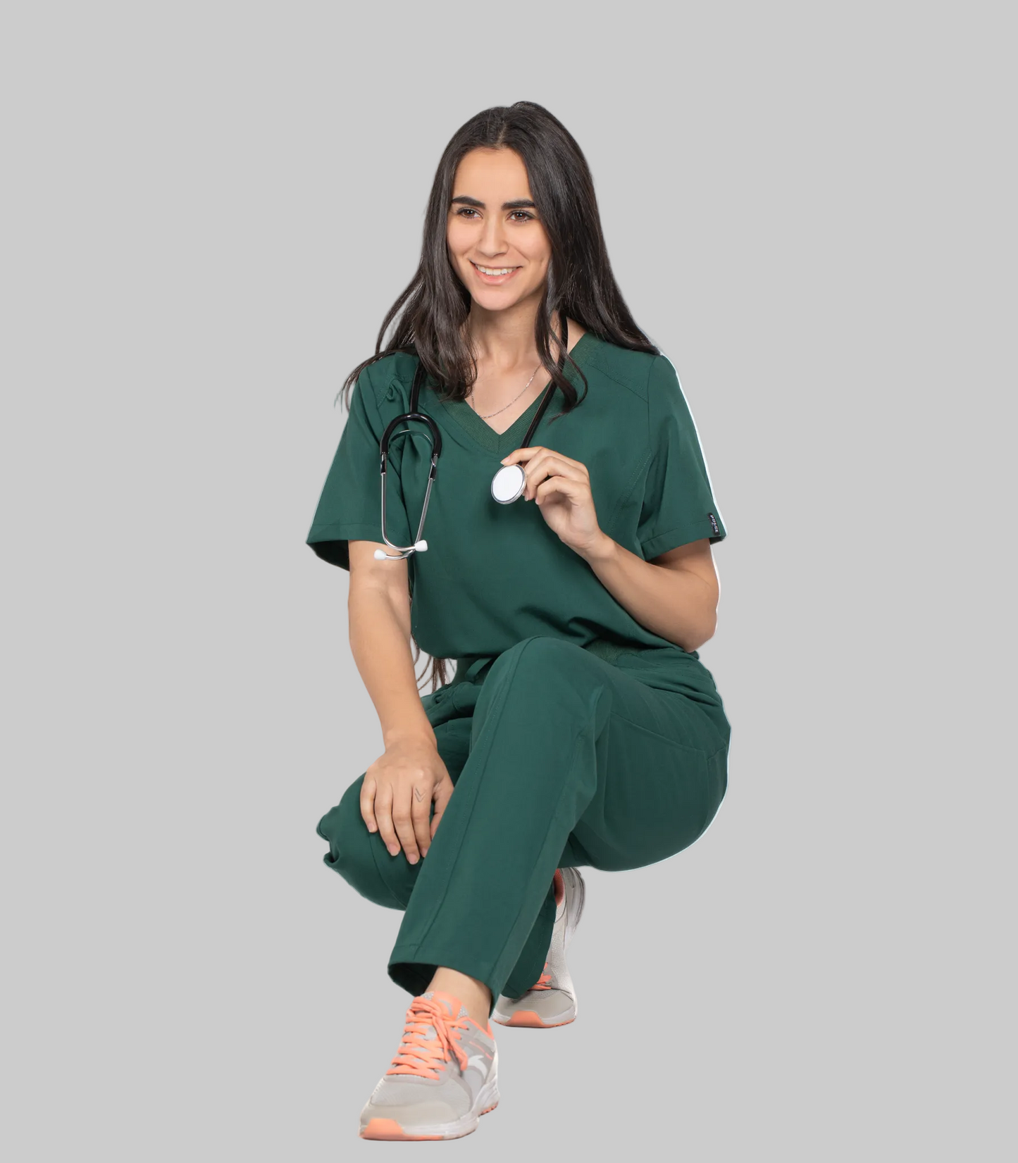 Woman in green medical scrubs holding a stethoscope on a white background with 'Pulse' branding.